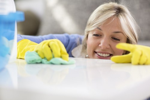 Detailed cleaning of a living space in Merton with attention to dust and high-touch areas