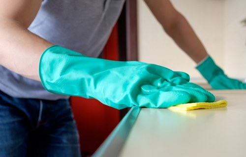 Local technician treating a fresh spill on a sofa in a Merton home